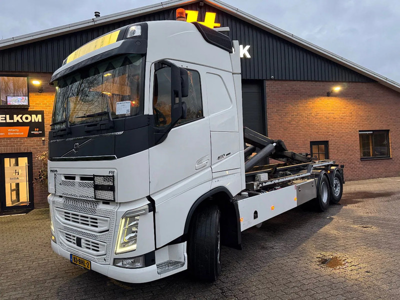 Volvo FH 460 6X2 VDL 25T Haakarm Standairco 9T Vooras Stuuras NL Truck - Hook lift truck: picture 1 Volvo FH 460 6X2 VDL 25T Haakarm Standairco 9T Vooras Stuuras NL Truck - Hook lift truck: picture 1